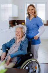 Portrait of nurse and her senior client on a wheelchair. - HPIF32825