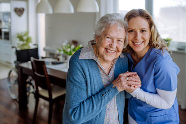 Nurse hugging her senior woman client. - HPIF32837