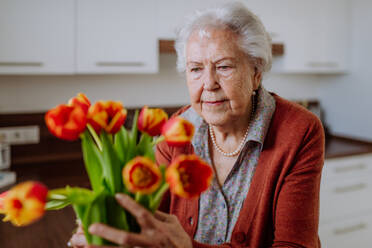 Portrait of senior woman with bouquet of flowers. - HPIF32879