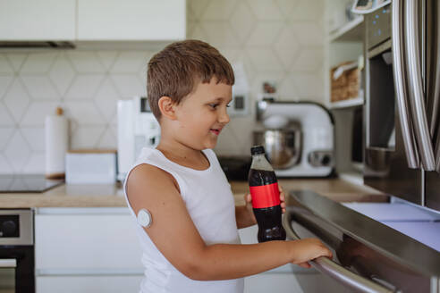 Diabetic boy with a continuous glucose monitor can't drink sweetened soda, sugar drink. - HPIF32942