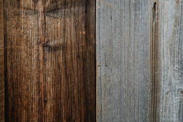 Close-up texture of gray and brown rustic wood grain. Natural wooden board background for design and decoration. High-quality image of hardwood surface. Transition between brown and gray wooden plank. - HPIF32949