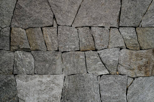 Close-up texture of stone paving or wall, stone cladding or facade of building. Natural stone background suitable for design and decor. - HPIF32950