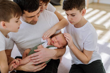 Portrait of a father and his four sons, holding his newborn baby. - HPIF32980