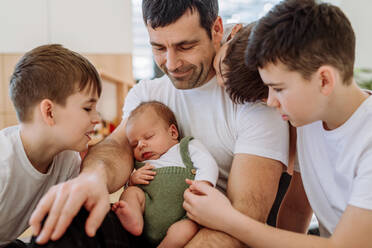 Portrait of a father and his four sons, holding his newborn baby. - HPIF33006