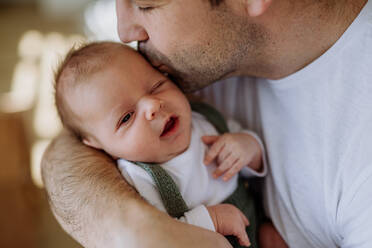 Close-up of father holding and kissing his little new born baby. - HPIF33020