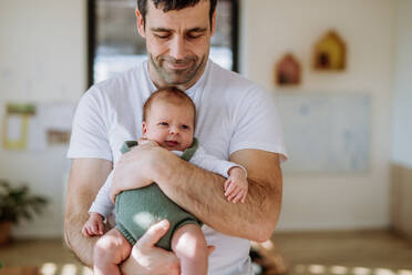 Close-up of father holding his little new born baby. - HPIF33024