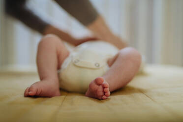 Close up of babys feet lying in cradle. - HPIF33068