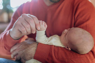 Close-up of father holding his little new born baby. - HPIF33096