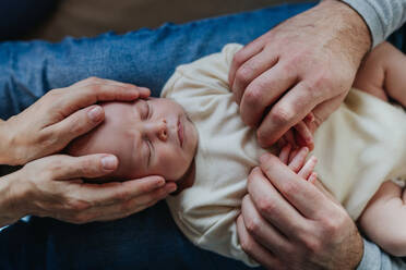 Close-up of parents cuddling their newborn son. - HPIF33103