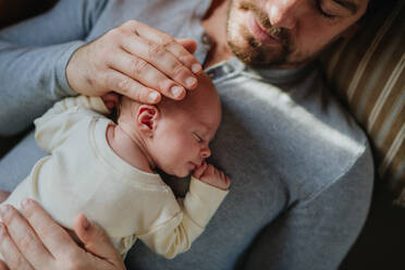 Close-up of father cuddling his little new born baby. - HPIF33107