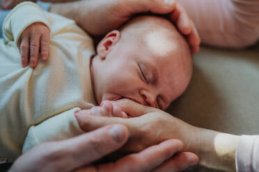 Close-up of parents cuddling their newborn crying son. - HPIF33110