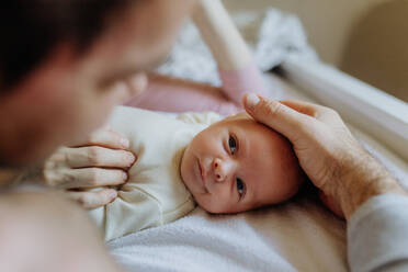 Close-up of parents cuddling their newborn son. - HPIF33136