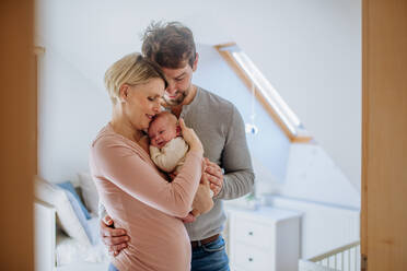 Parents holding their newborn son in their home. - HPIF33143