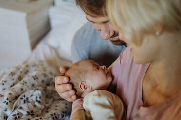 Close-up of parents cuddling their newborn son. - HPIF33146