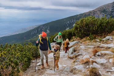 Happy family hiking together in an autumn mountains. - HPIF33521