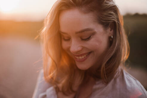 Portrait of a beautiful woman outdoor during sunset. - HPIF33852