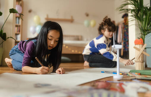 Happy friends drawing together in the room. - HPIF33971