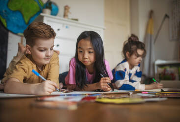 Happy friends drawing together in the room. - HPIF33978