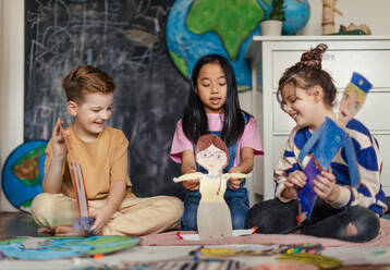 Little children playing with beautiful handmade puppets. - HPIF33984