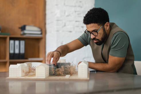 Young multiracial architect designing building in his office. - HPIF34040