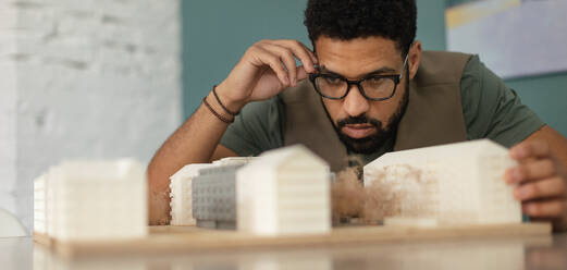 Young multiracial architect designing building in his office. - HPIF34041