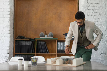 Young multiracial architect designing building in his office. - HPIF34044