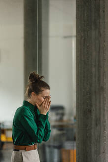 Young sad woman in office, facing a problems at work. Signs of burnout at work. Workplace issues. - HPIF34065