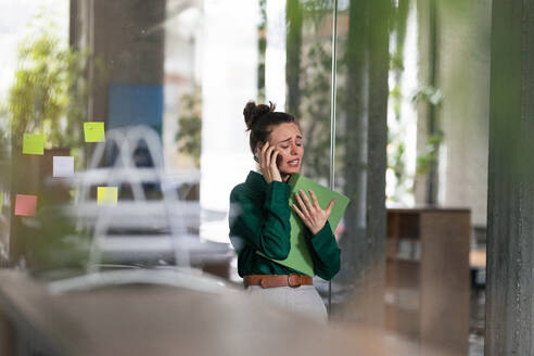 Young sad woman in office, having troubles. - HPIF34067