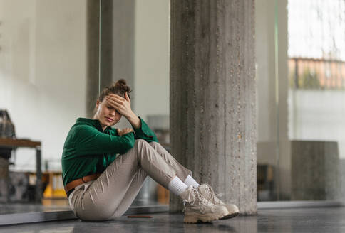 Young sad woman in office, having troubles. - HPIF34071