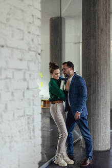 Mature man abusing his younger colleague, concept of harassment at work. Young female feeling under pressure, lacking personal space. - HPIF34082