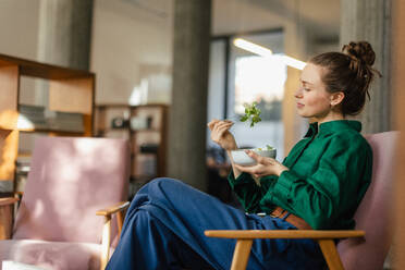 Young woman having lunch in the office. - HPIF34109