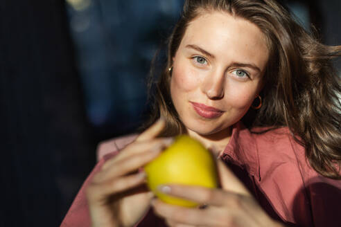 Portrait of young beautiful woman with apple. - HPIF34133