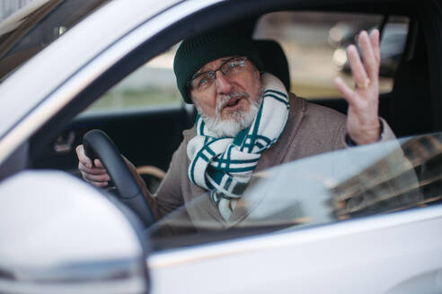 Angry senior man driving a car, close-up. - HPIF34158