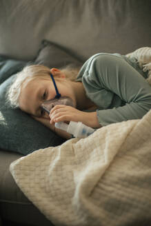 LIttle sick girl using an inhaler during flu. - HPIF34160