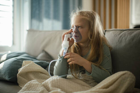 LIttle sick girl using an inhaler during flu. - HPIF34161