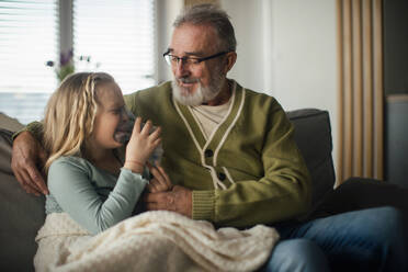 Senior man taking care of sick granddaughter. - HPIF34164