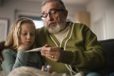 Senior man taking care of sick granddaughter. - HPIF34165