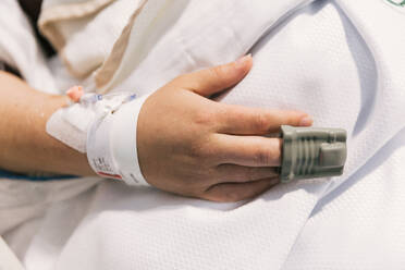 Close-up view of a patient with a pulse oximeter on finger at hospital. Health care concept. - ADSF50181