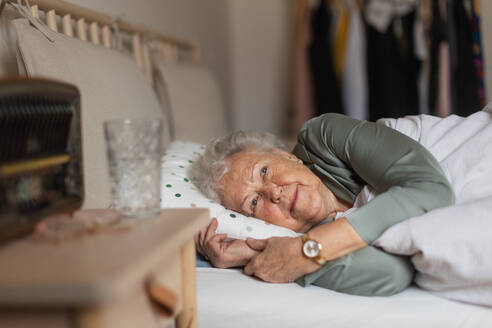 Senior woman sleeping in her bed alone. Loneliness and social isolation of eldery woman. - HPIF34284