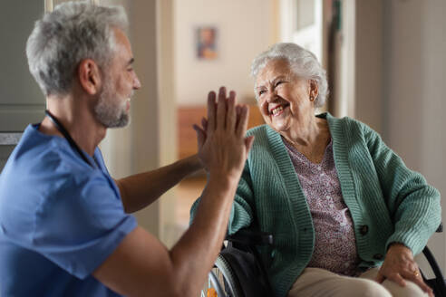 Caregiver spending time with his senior woman client. - HPIF34293