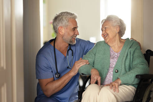 Caregiver doing regular check-up of senior client in her home. - HPIF34296