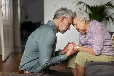 Portrait of mature man with his senior mother. Coping with grief, loss together. - HPIF34346