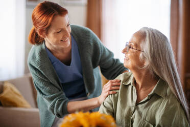 Nurse cosulting with senior woman her health condition at her home. - HPIF34387