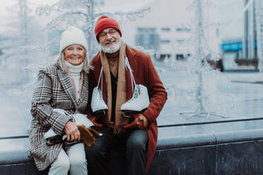 Portrait of seniors in winter at an outdoor ice skating rink. - HPIF34445