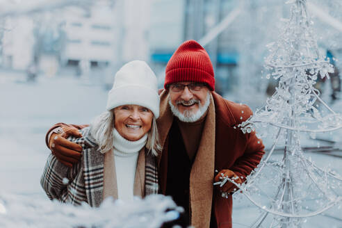 Senior couple walking in a winter city center. - HPIF34447