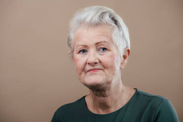 Portrait of smiling senior woman in a studio. - HPIF34597