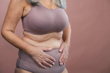 Close-up of a senior woman body, studio shoot. - HPIF34629