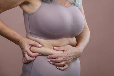 Close-up of a senior woman body, studio shoot. - HPIF34630