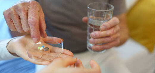 Close up of senior man taking medicines. - HPIF35011