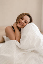 Portrait of young woman at morning in a bed. - HPIF35250